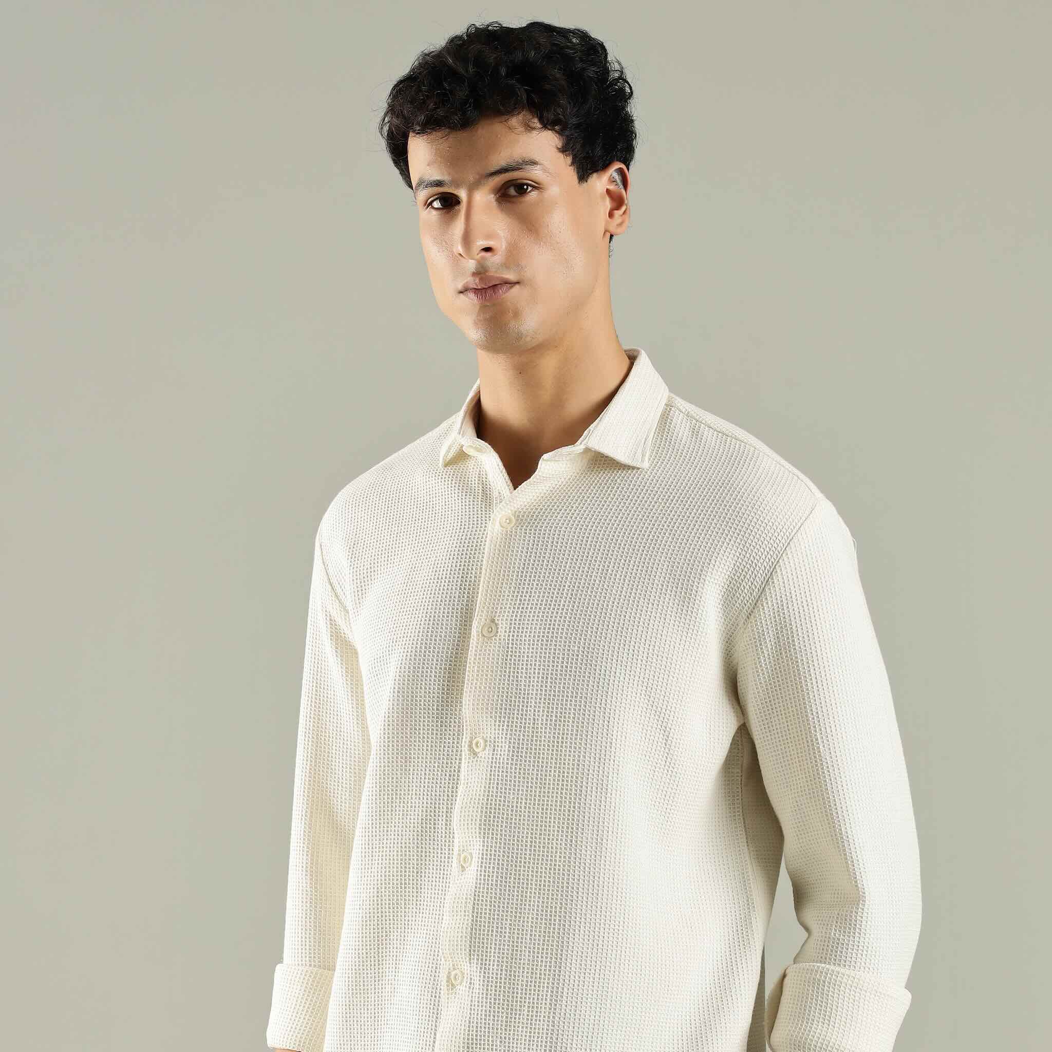 Man wearing a light-colored shirt against a plain background