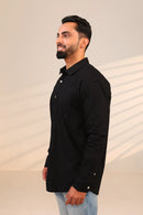Man in black shirt looking sideways.
