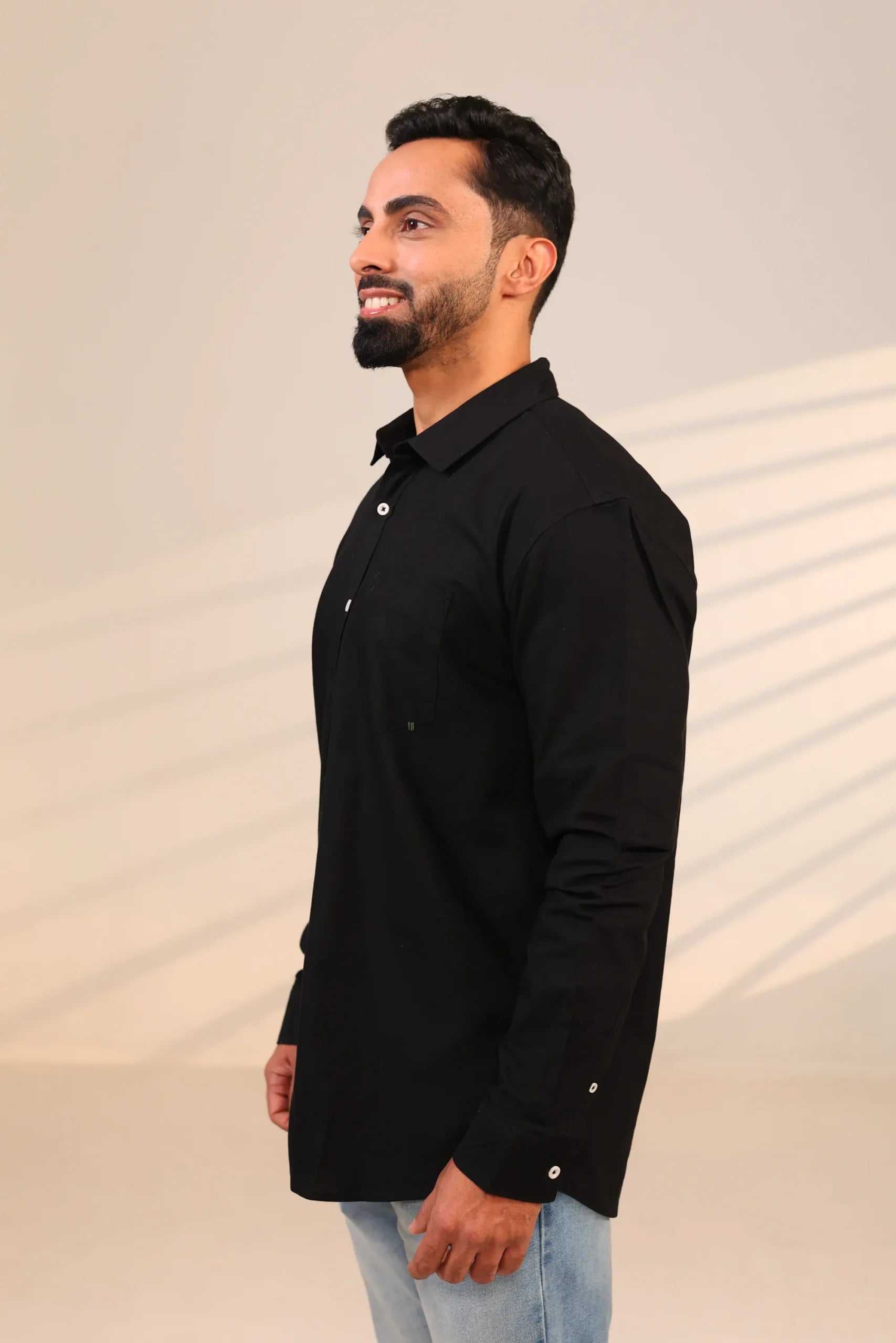Man in black shirt looking sideways.