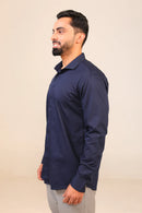 Man in navy shirt side profile view.
