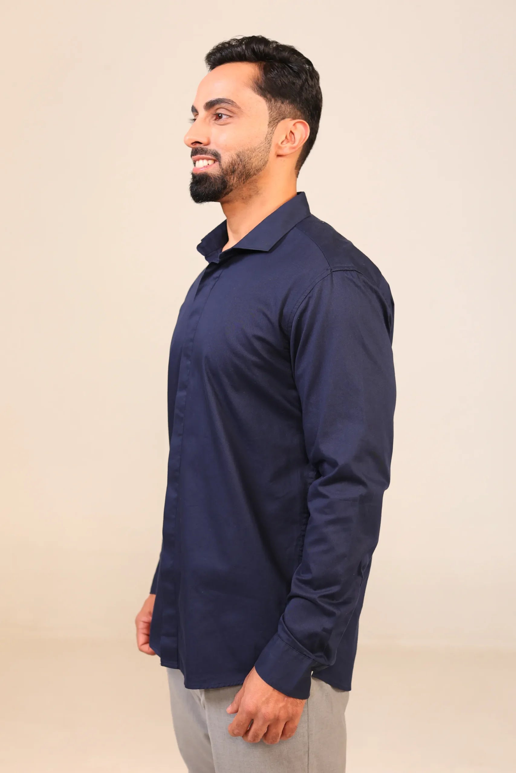 Man in navy shirt side profile view.