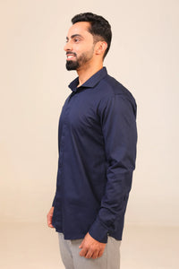 Man in navy shirt side profile view.