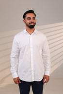 Man in white shirt looking slightly left.
