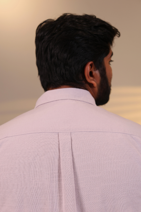 close-up view in lavender shirt, side pose with smile