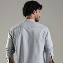 Man wearing a light blue shirt against a plain background