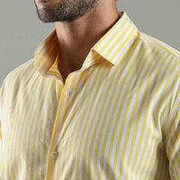 Man wearing a yellow and white striped shirt against a gray background