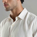 Man wearing a light-colored shirt against a neutral background