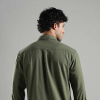 Man wearing a green hemp shirt against a gray background