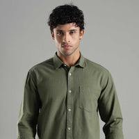 Man wearing a green hemp shirt against a gray background