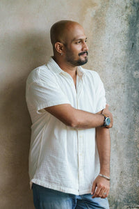 Man in white shirt with arms crossed